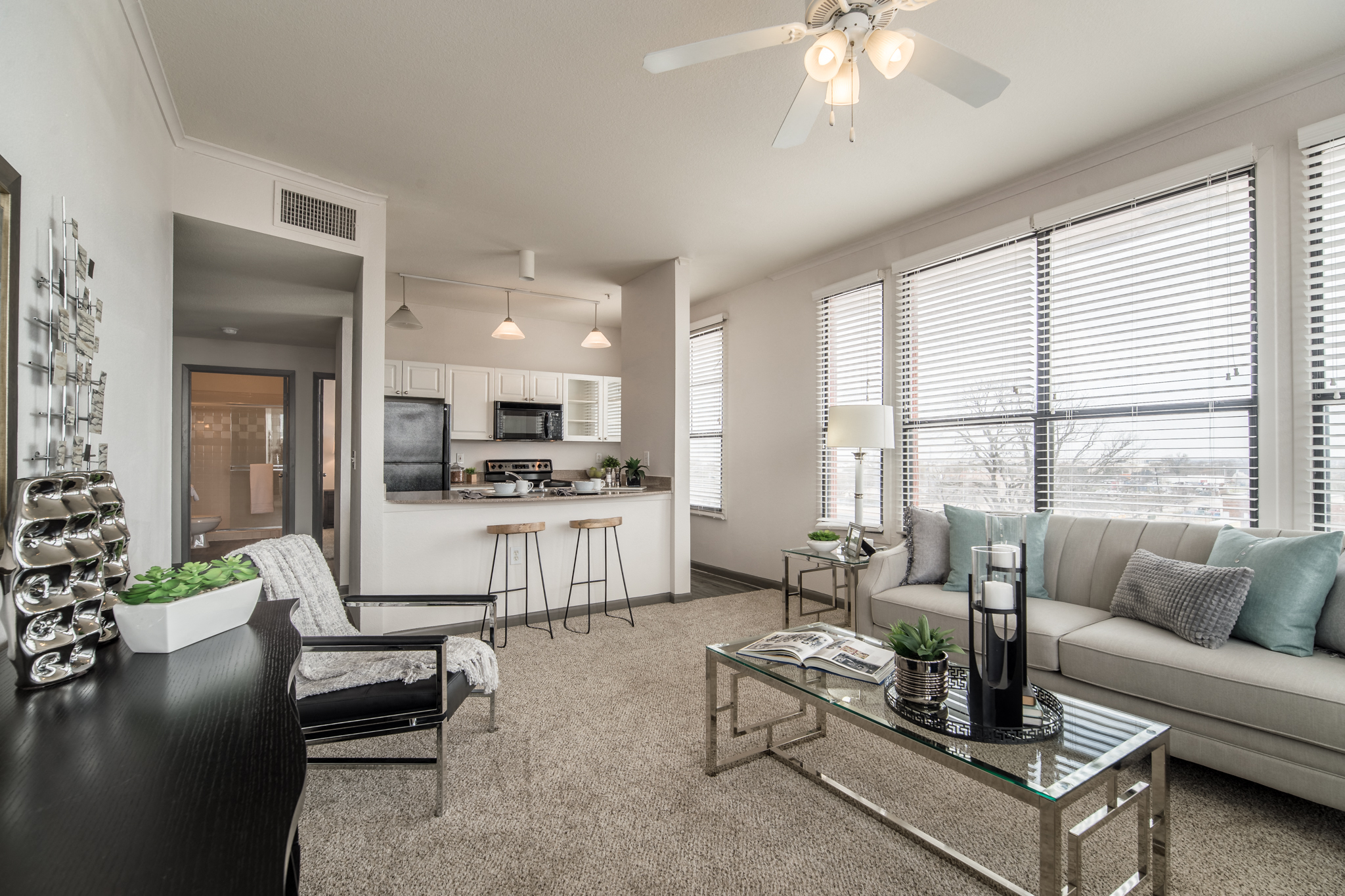 an open living room and kitchen with a couch and a table