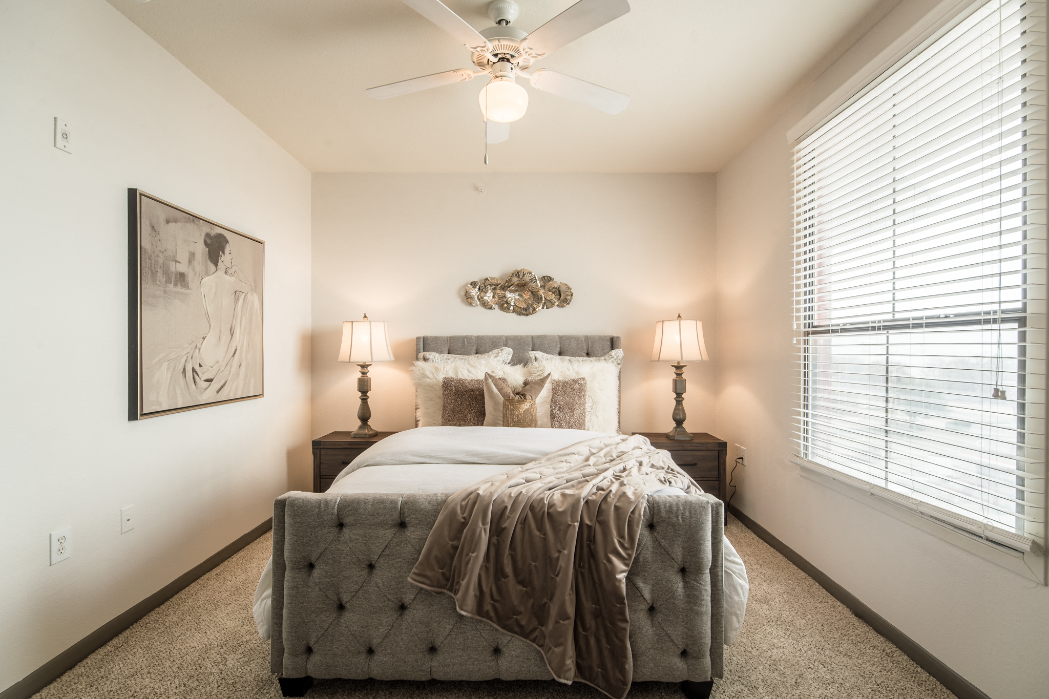 a bedroom with a bed and a ceiling fan
