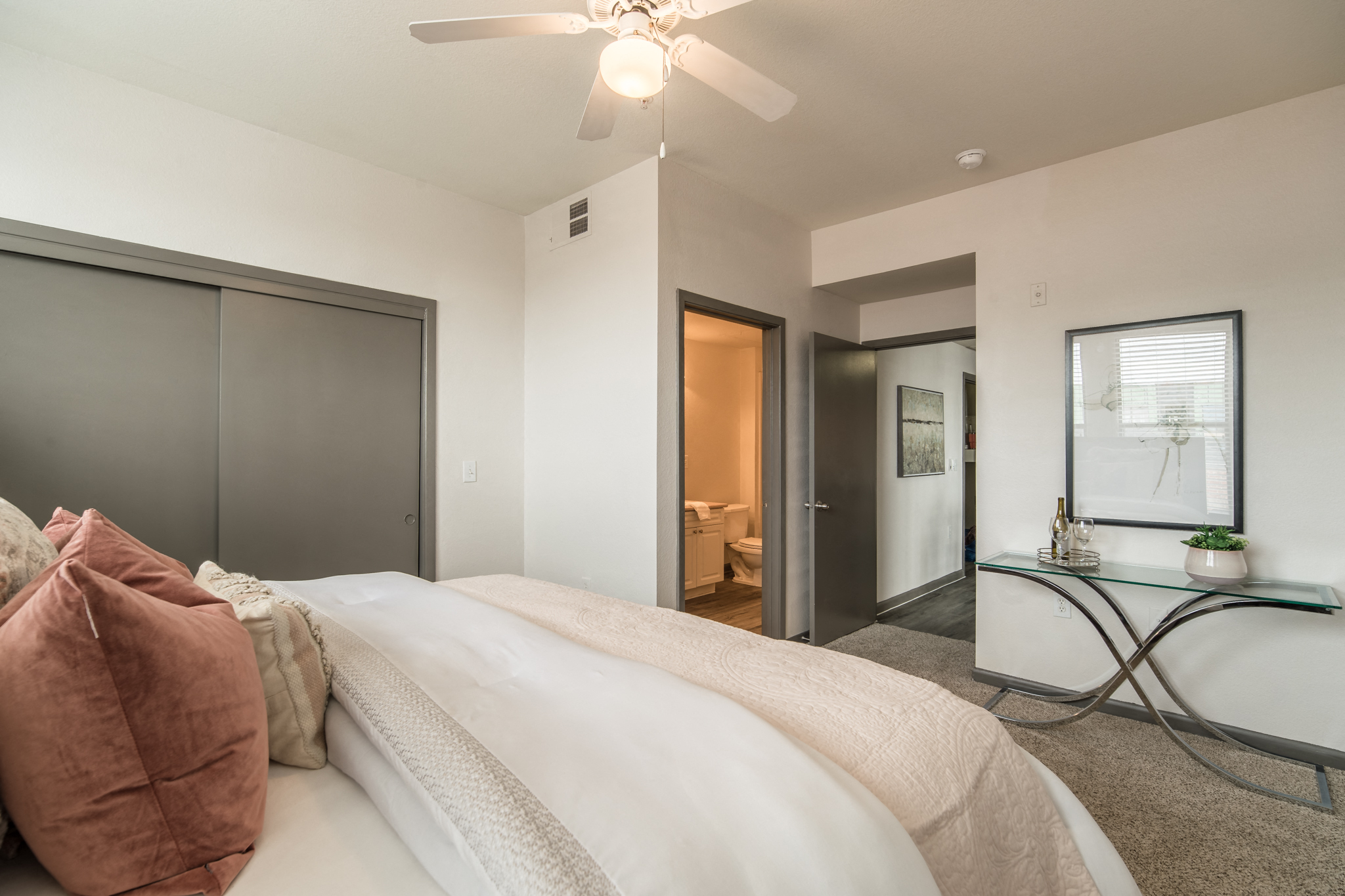 a bedroom with a large bed and a ceiling fan