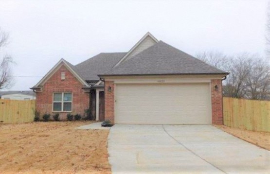 a brick house with a white garage door