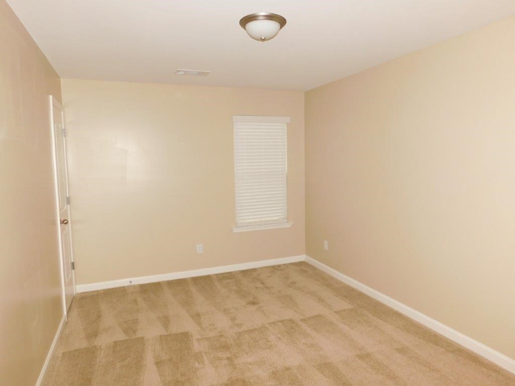 a empty room with beige walls and a door