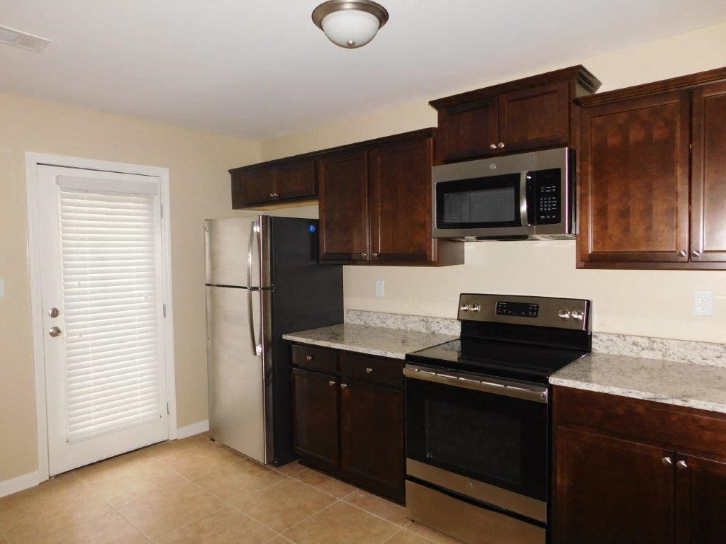 a kitchen with a stove microwave and refrigerator