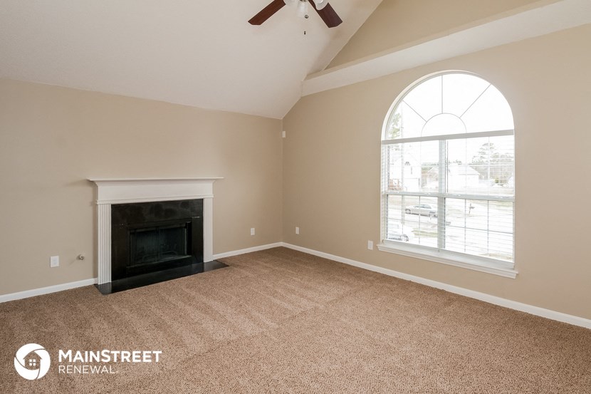 a living room with a fireplace and a window