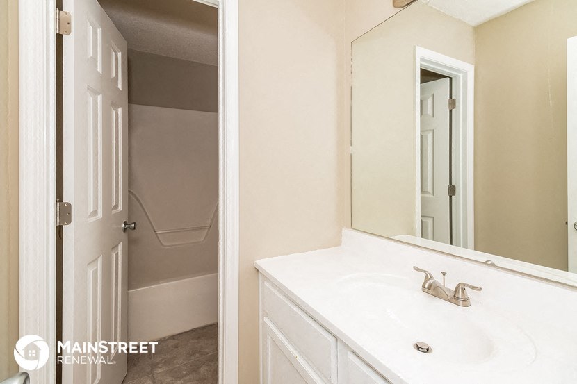 a bathroom with a sink and a mirror and a shower