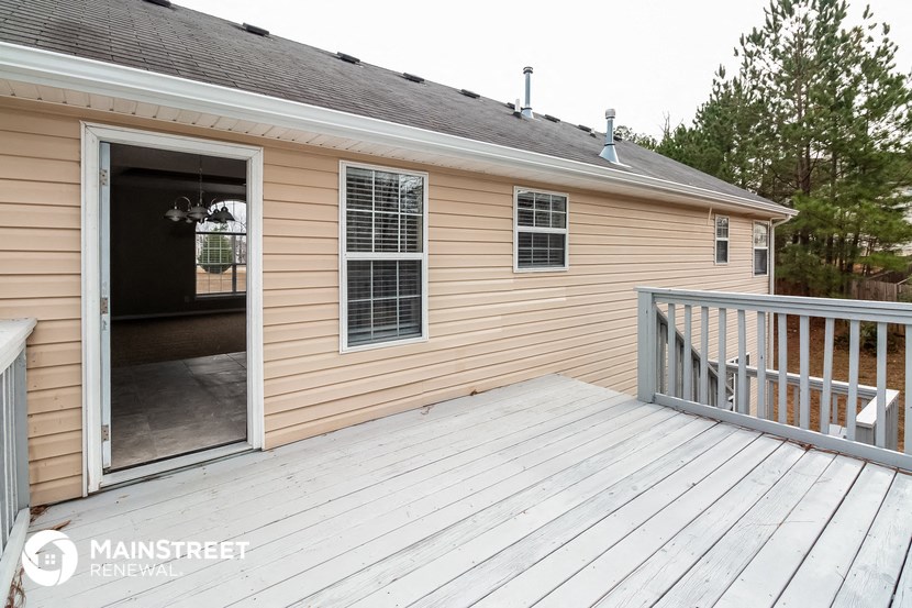 the deck has a view of the yard and the house