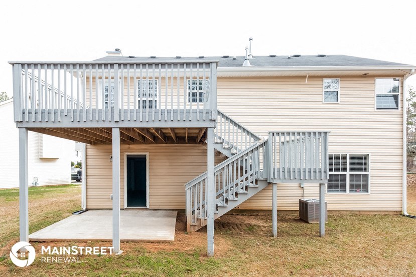 a house with a deck and a staircase on top of it