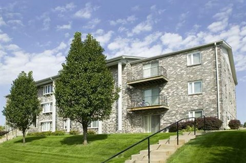 a stone building with a tree in front of it