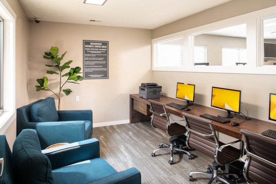 a conference room with three computer desks and chairs