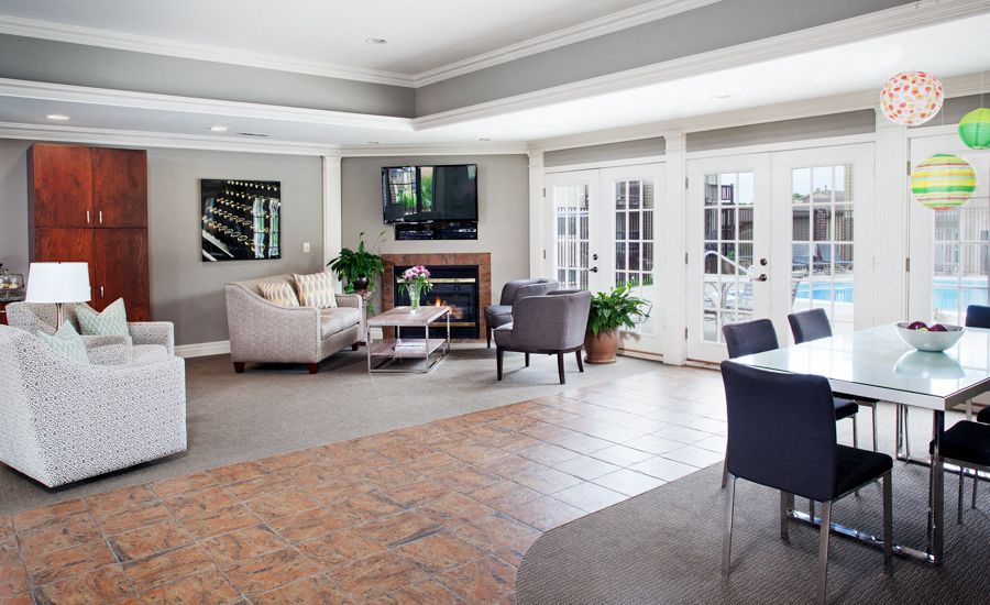a living room with a table and chairs and a television