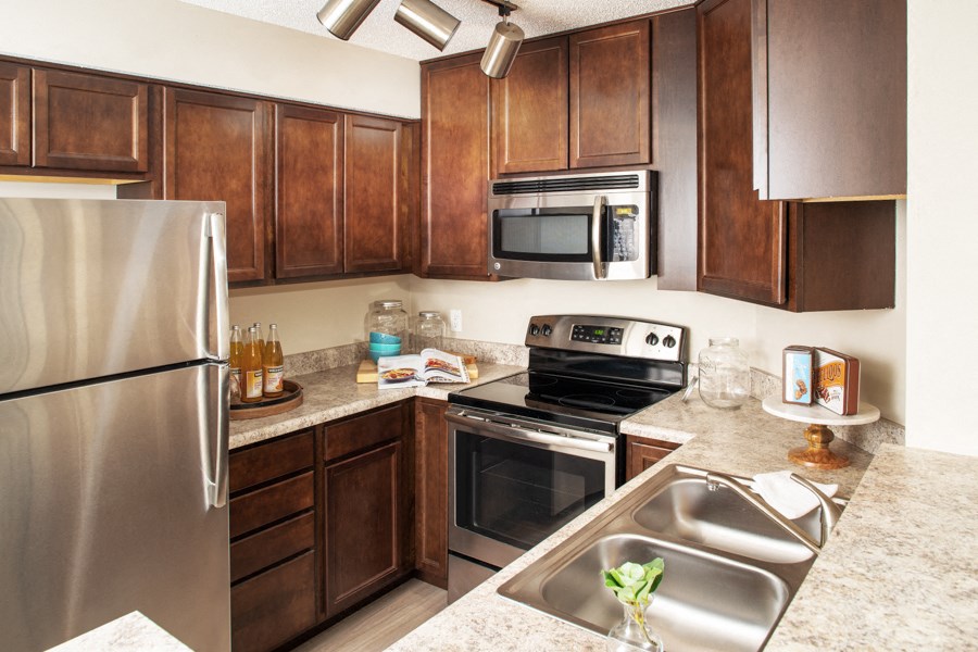 a kitchen with stainless steel appliances and wooden cabinets