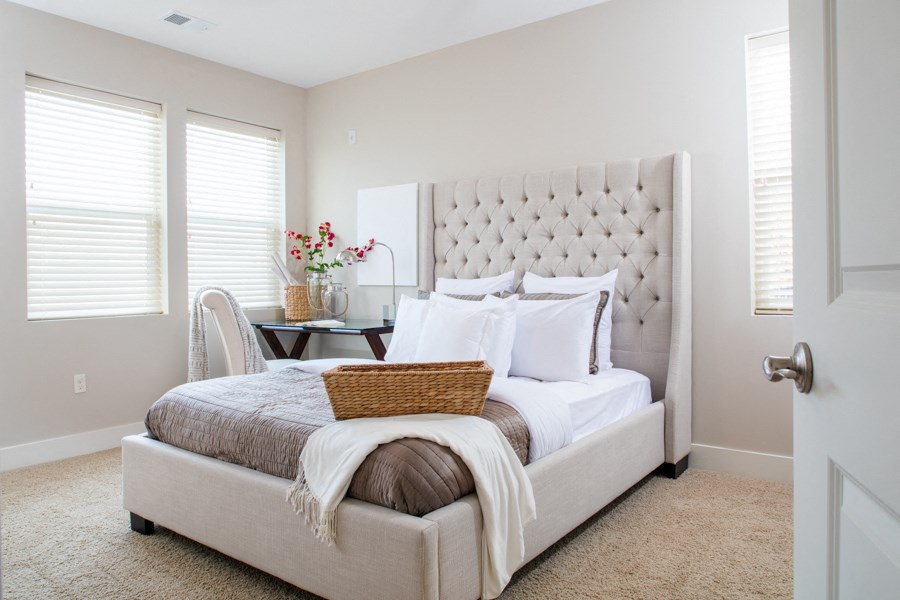 a bedroom with a bed and a chair and a table