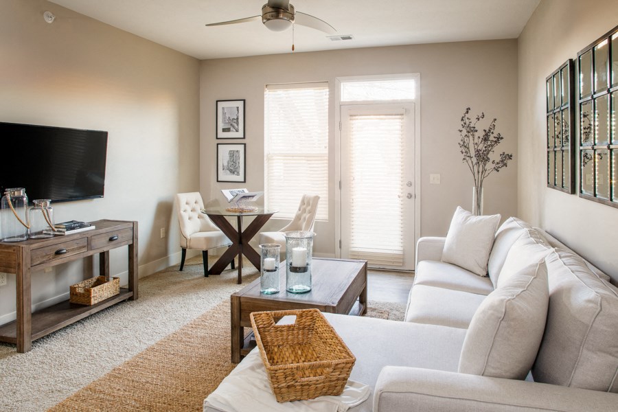 a living room with a white couch and a television
