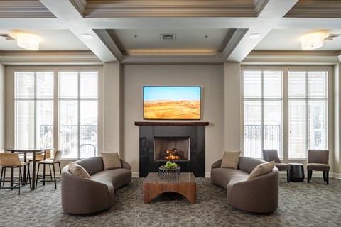 A living room with a fireplace and a television on the wall.
