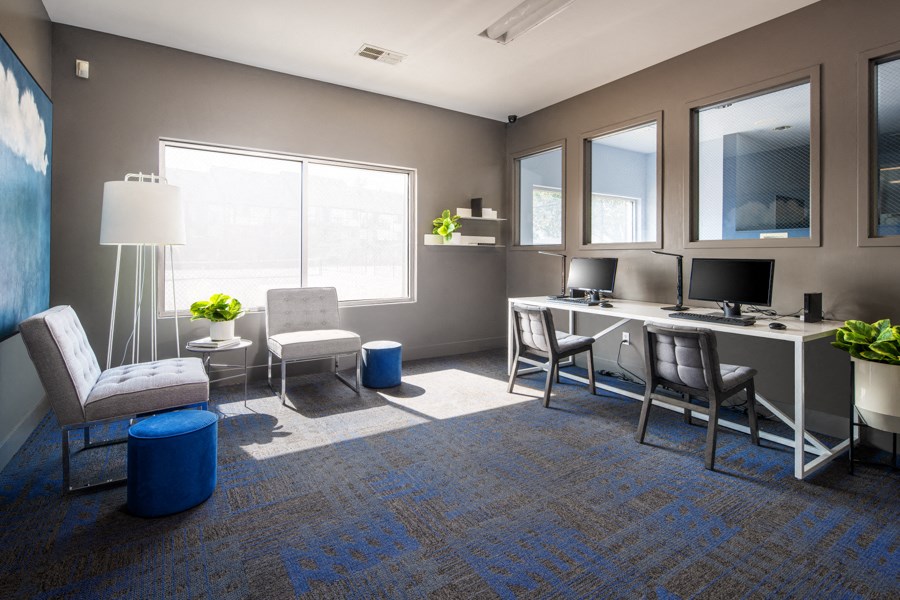 a rendering of an office space with a desk and chairs and a computer