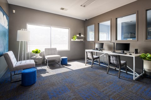 a rendering of an office space with a desk and chairs and a computer