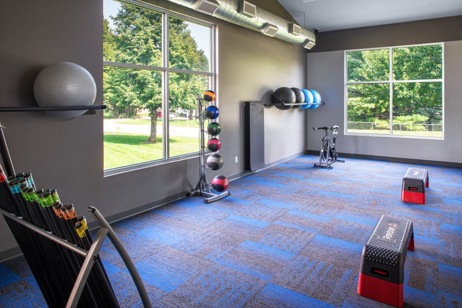 a gym with a large window and a bike in the corner