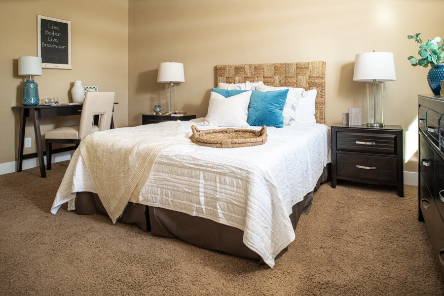 a bedroom with a bed and a desk with a chair