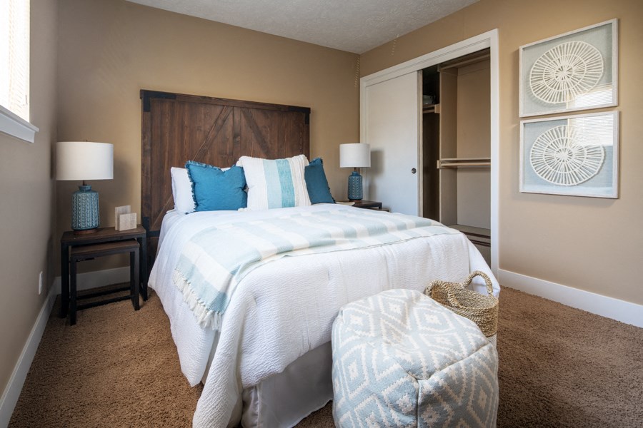 a bedroom with a large bed and a closet