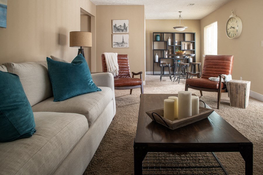 a living room with a couch and a table with candles