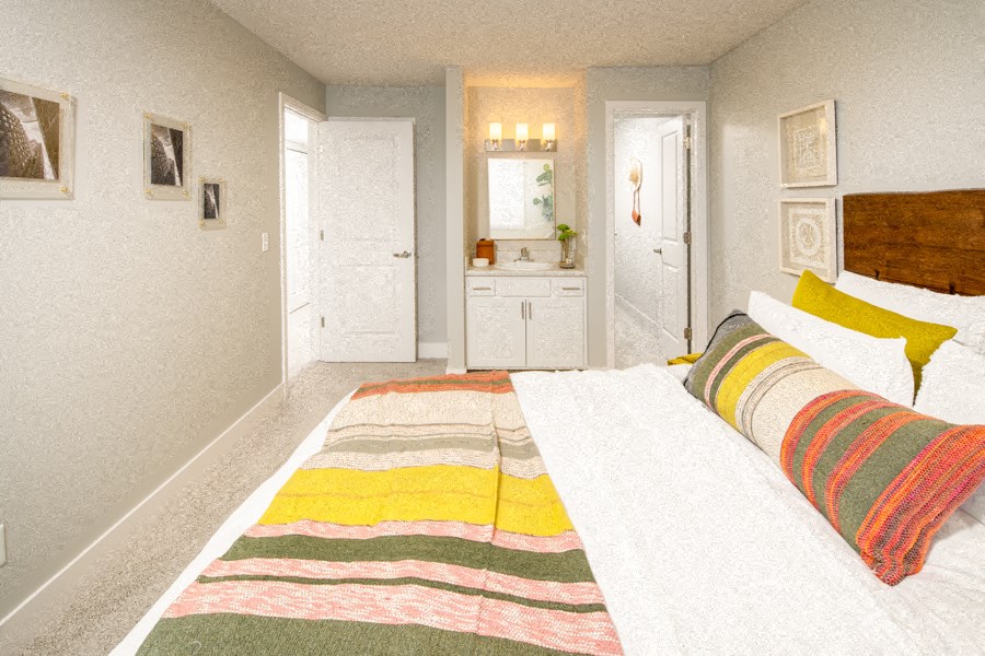 a bedroom with a bed and a sink in it