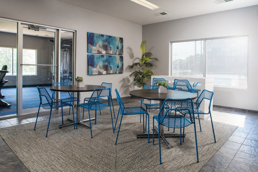 a conference room with blue chairs and tables and a large window