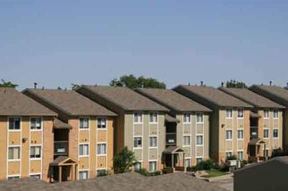 a row of brick apartment buildings on top of a roof