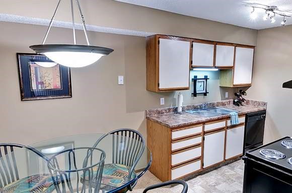 a kitchen and dining room with a glass table and chairs