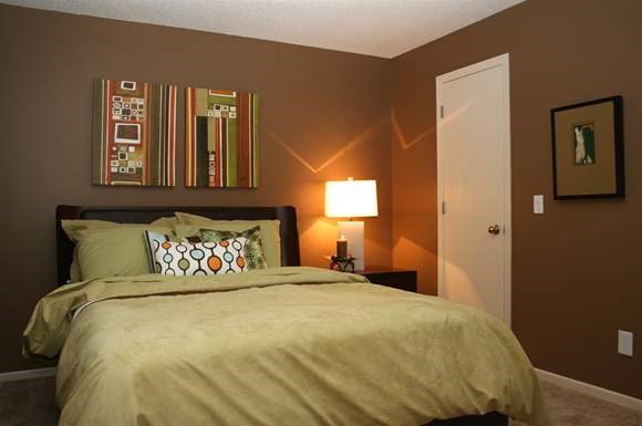 a bedroom with a bed and a lamp