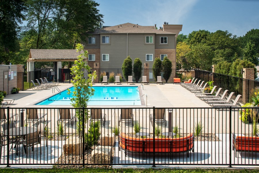 our apartments have a large pool and a patio with chairs