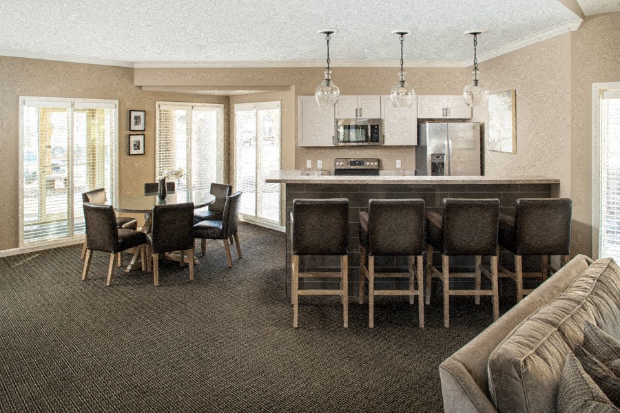 a view of a living room with a bar and a kitchen