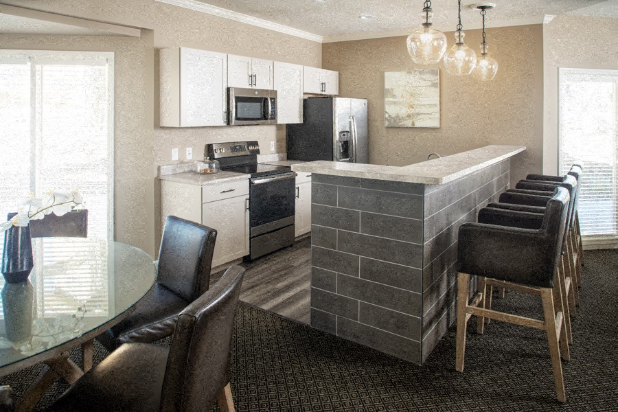 a kitchen and dining room with a table and chairs