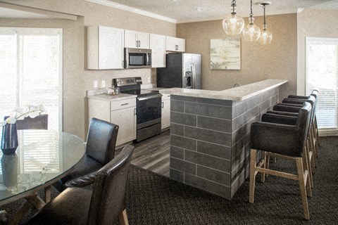 a kitchen and dining room with a table and chairs