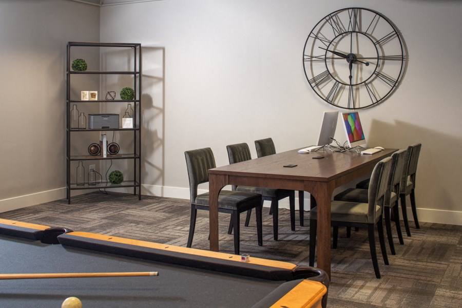 a conference room with a table and a billiards table