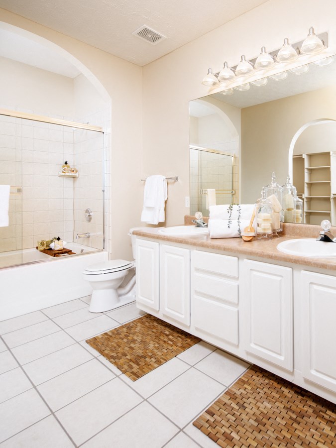 a white bathroom with a toilet and a tub and a sink