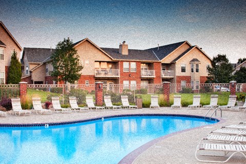 an image of a swimming pool in front of a house