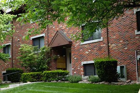a brick building with a tree in front of it