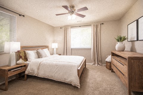 a bedroom with a bed and a ceiling fan