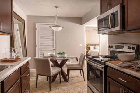 a kitchen and dining room with a table and chairs