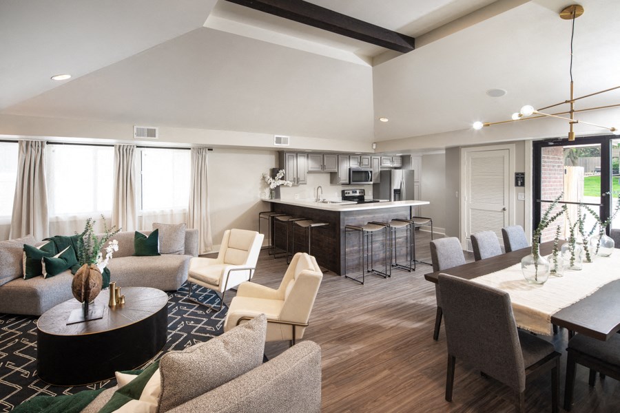 a living room and kitchen with a table and chairs
