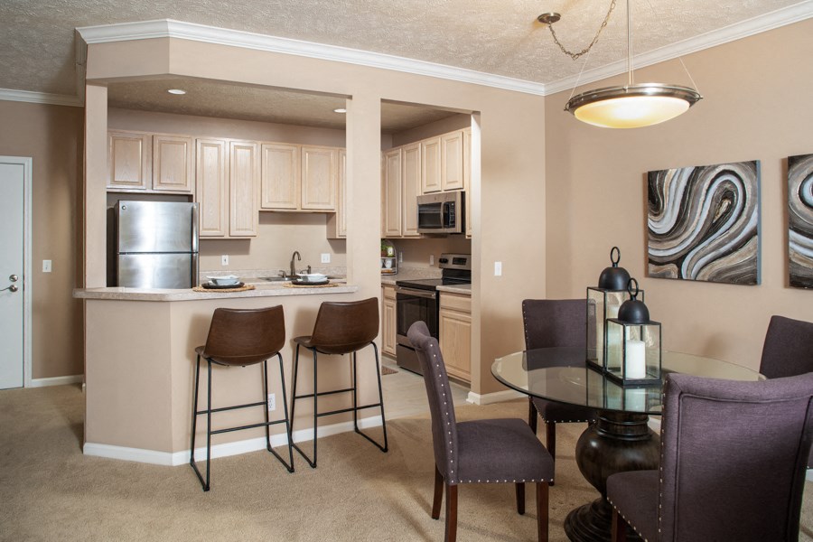 a kitchen and dining room with a table and chairs