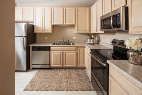 A kitchen with wooden cabinets and a black oven.