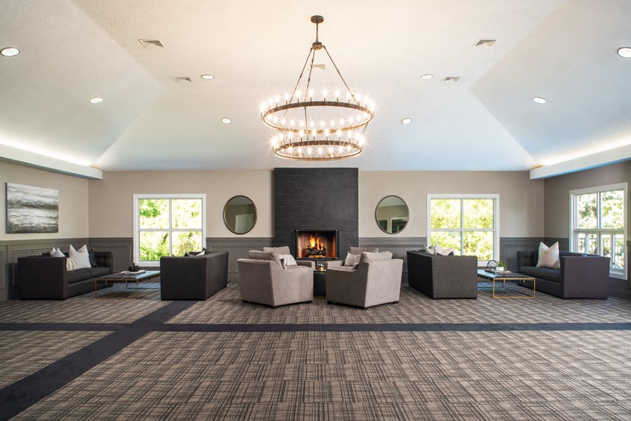 a large living room with couches and a fireplace