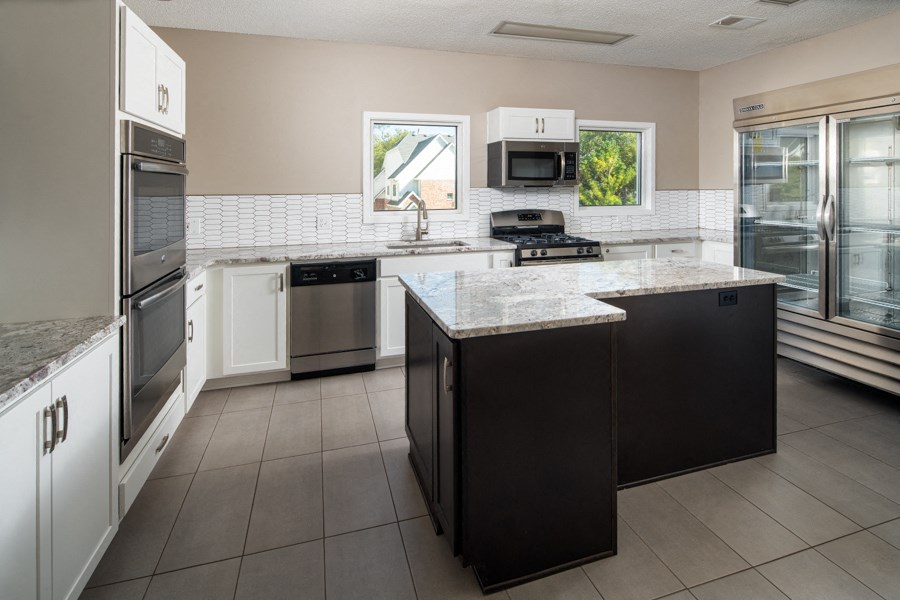a kitchen with an island and stainless steel appliances
