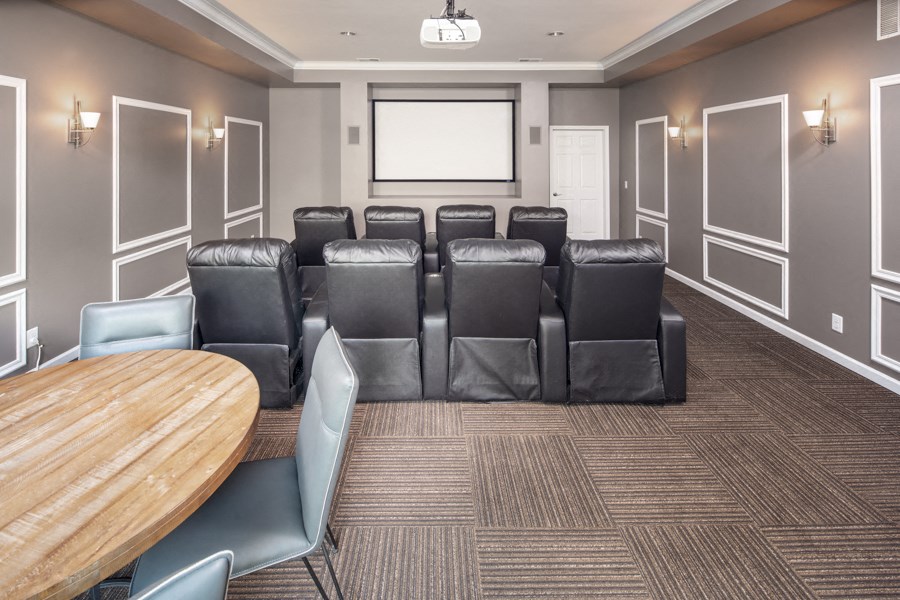 a conference room with leather chairs and a table