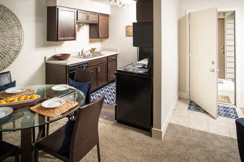 a kitchen and dining room with a table and chairs