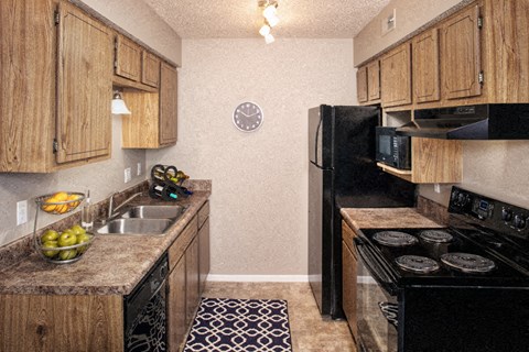 a kitchen with a stove refrigerator and sink