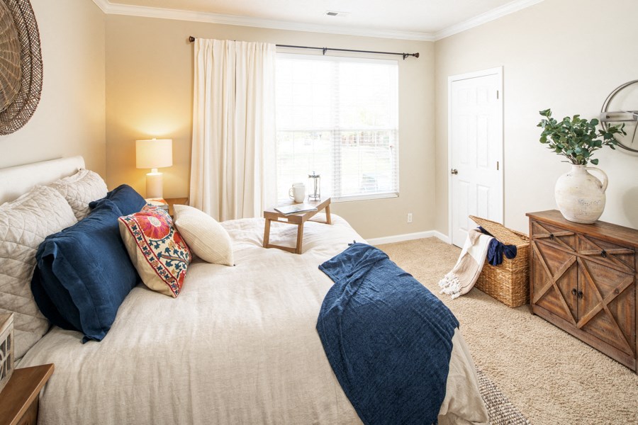 a bedroom with a bed and a large window