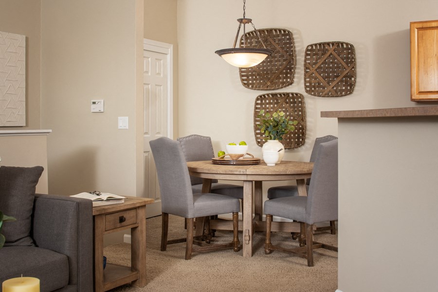 a dining room with a wooden table and chairs