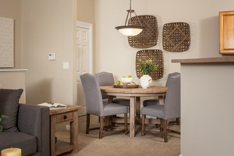 a dining room with a wooden table and chairs