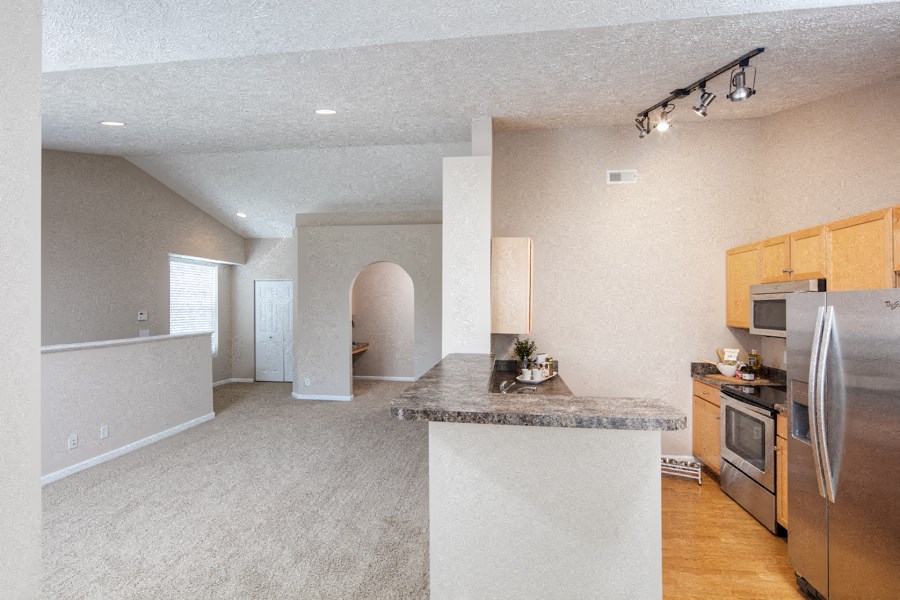a kitchen with stainless steel appliances and a granite counter top